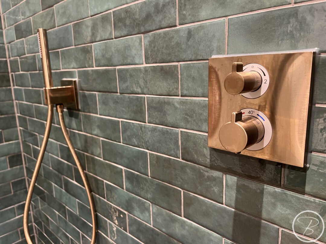 lose up of shower controls and outlet
